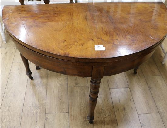 A Victorian walnut demi-lune folding table, W.3ft 10in.